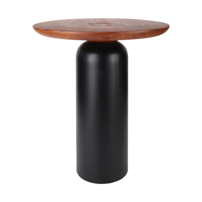 SUVI wooden side table with a sleek cylindrical black base and a round wooden top, styled in a bedroom setting. On top of the table are two books, a cup of tea, and a silver teapot, adding a warm and inviting touch to the room.